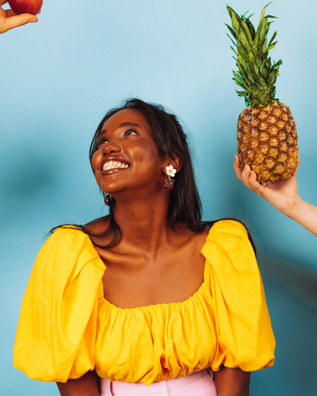 Femme portant des boucles d'oreilles originales en forme de mures