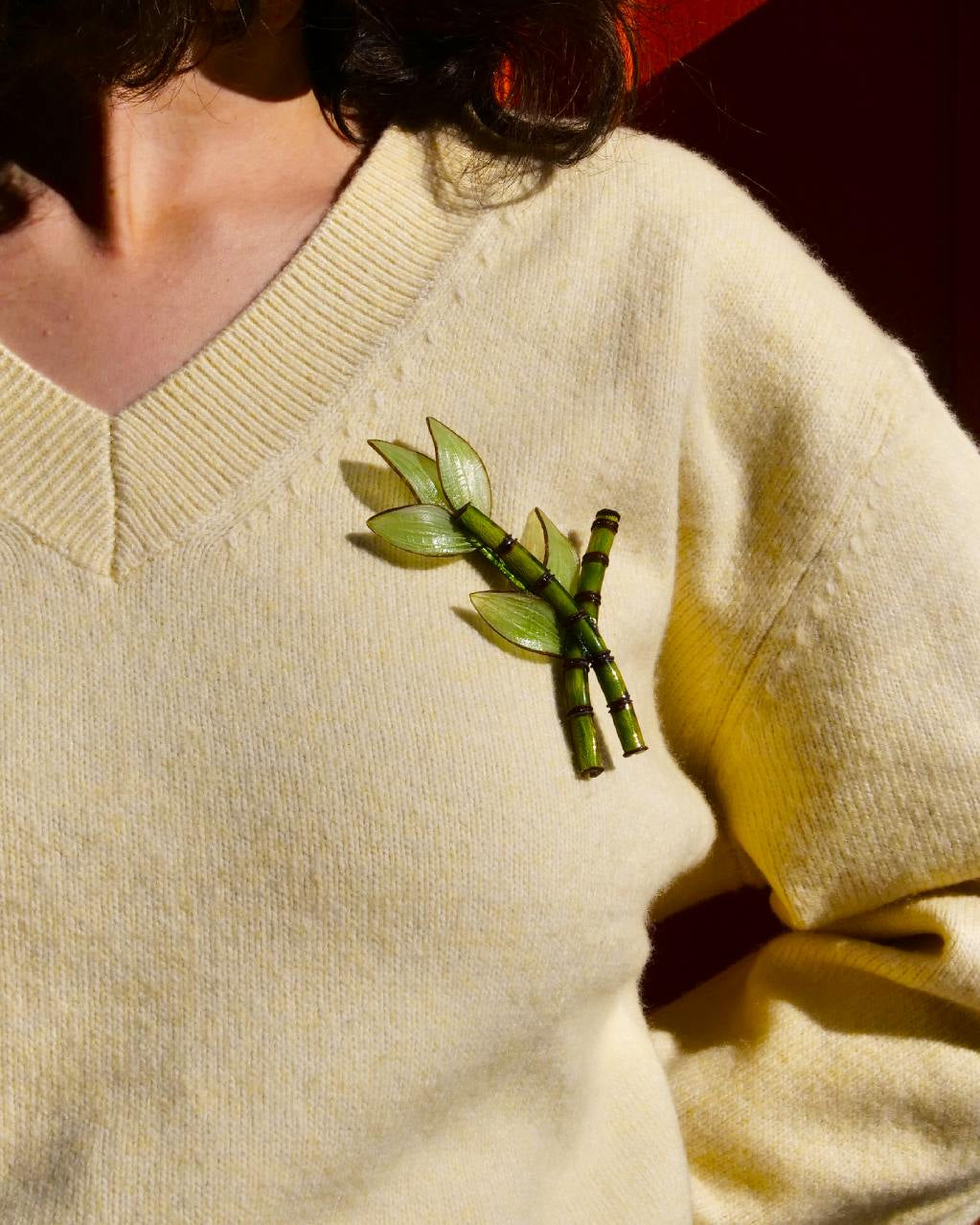 all-groups jolie bijou broche bambou sur un pull jaune pale