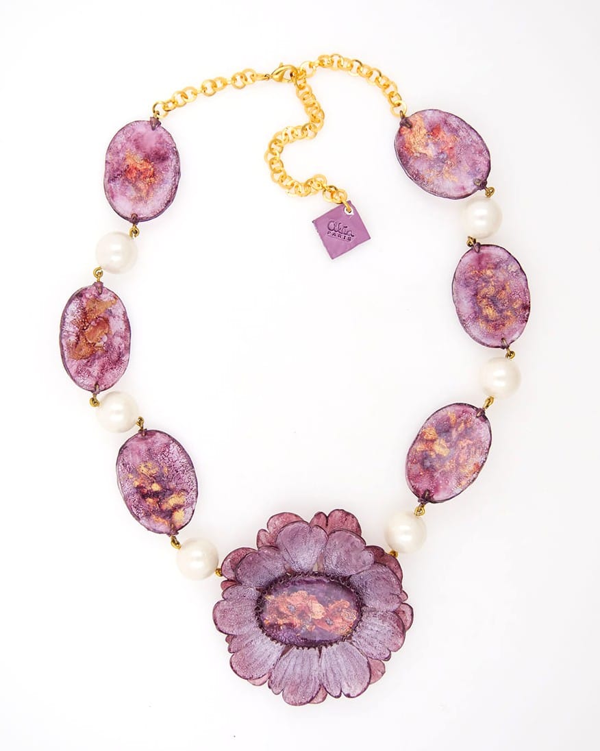 Cette pièce unique n°4 est un collier fantaisie femme violet, composé de plusieurs pièces et de 6 perles blanches accompagnés d'une chaîne dorée.