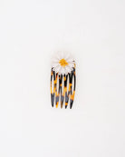 Ce petit peigne marguerite Daisy est composé d'une fleur blanche disposée sur un support de peigne en écaille.