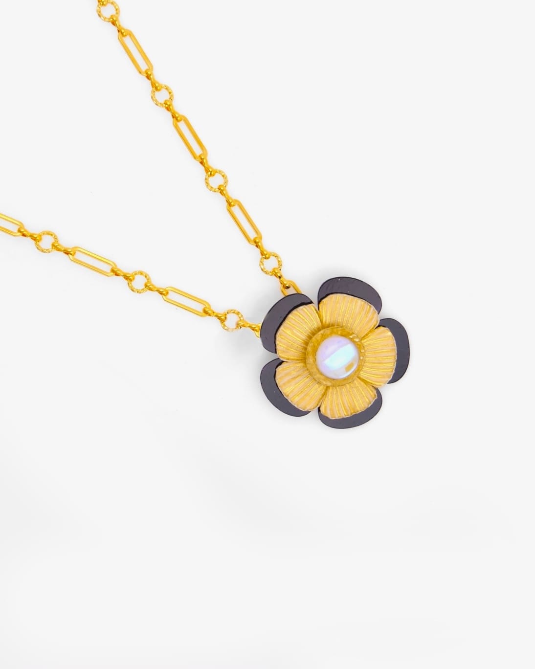 Chaque pendentif Mona est différent, ce collier fleur est composé de la fleur bicolore Mona, jaune et noire et d'une chaîne dorée.